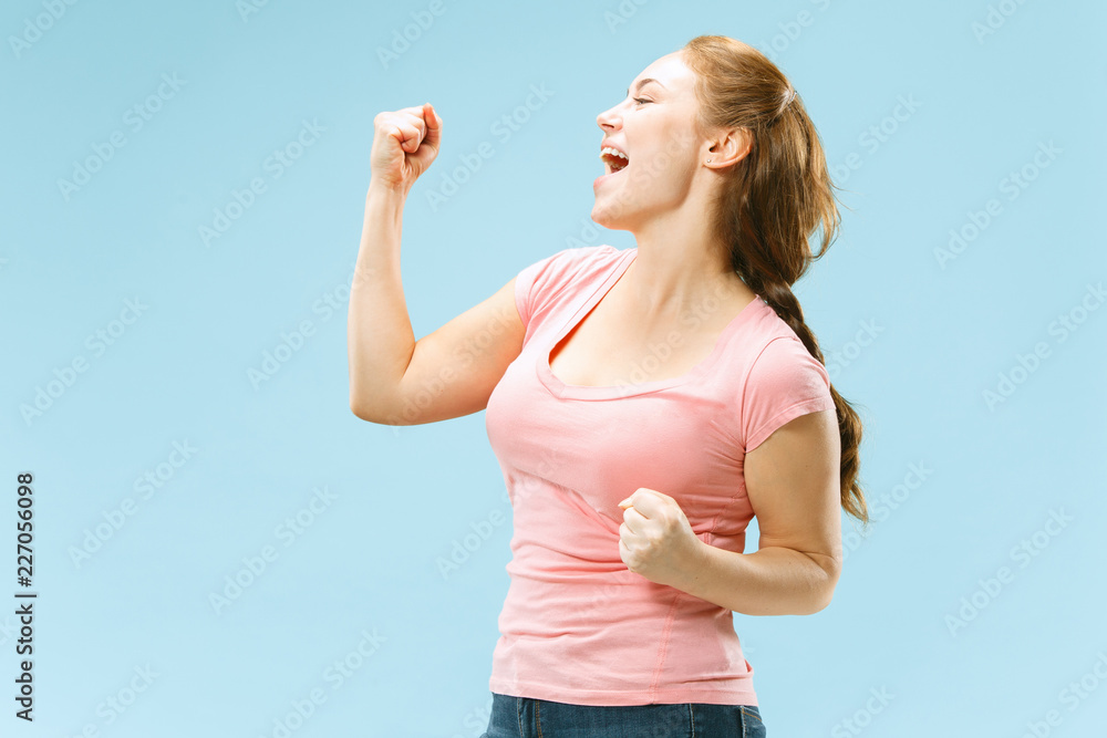 I won. Winning success happy woman celebrating being a winner. Dynamic image of caucasian female model on blue studio background. Victory, delight concept. Human facial emotions concept. Trendy colors I won. Winning success happy woman celebrating being a winner. Dynamic image of caucasian female model on blue studio background. Victory, delight concept. Human facial emotions concept. Trendy colors