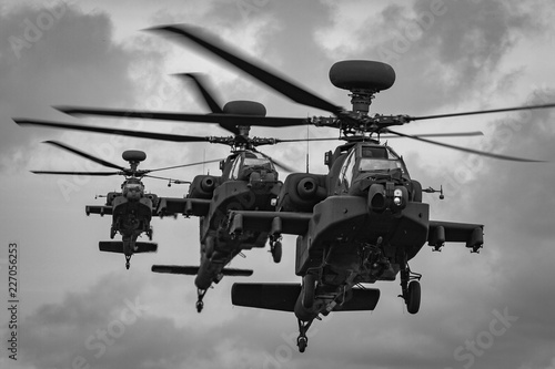 Fototapeta Naklejka Na Ścianę i Meble -  A line of three WAH-64 Apache Longbow attack helicopters coming into land, RAF Shawbury, Shropshire