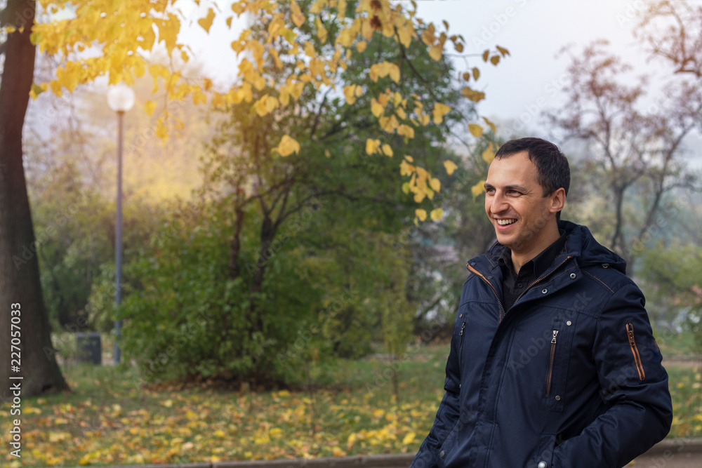 Handsome man walking in the autumn park Handsome man walking in the autumn park