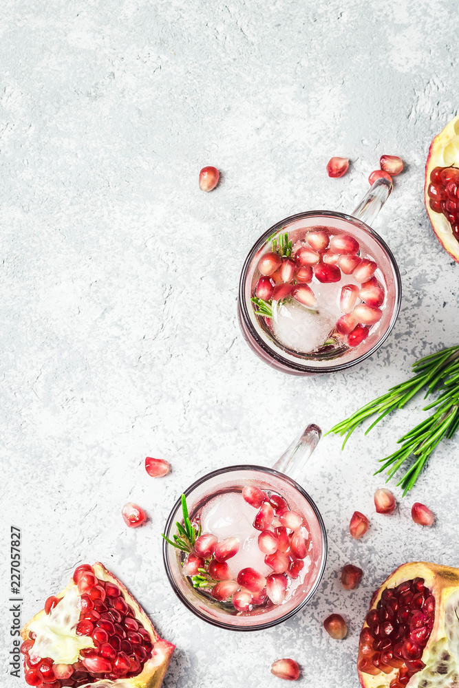 Rosemary pomegranate alcohol free mocktail with ice cubes. Top view, space for text. Rosemary pomegranate alcohol free mocktail with ice cubes. Top view, space for text.