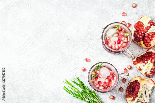 Rosemary pomegranate alcohol free mocktail with ice cubes. Top view, space for text.