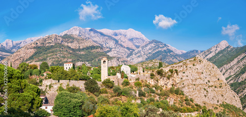 Panoramic view to medieval citadel within mountains in Old bar, Montenegro. Copy space in blue sky.