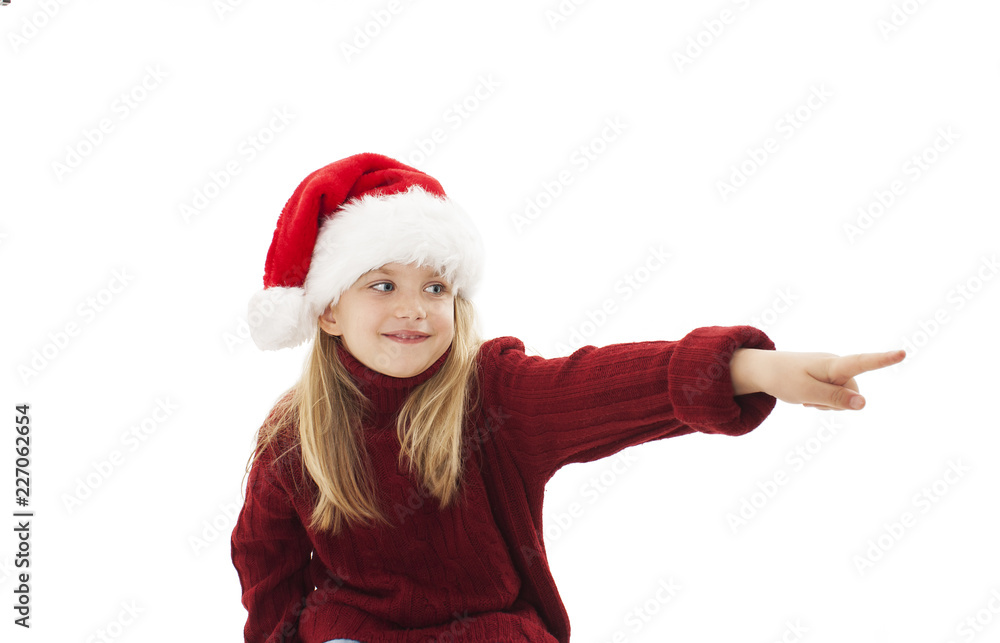 Christmas little girl pointing at copy space. Isolated on white background
Christmas little girl pointing at copy space. Isolated on white background