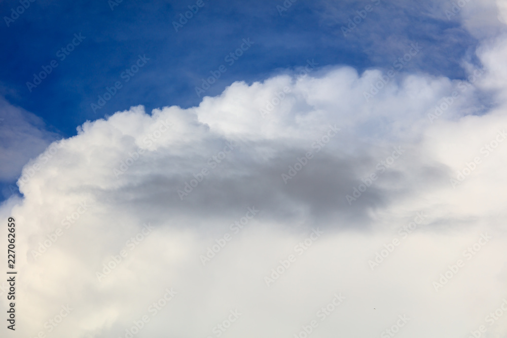 White creamy clouds in the sky as a background White creamy clouds in the sky as a background