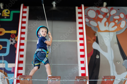 Young child crossing a bridge at the high rope course