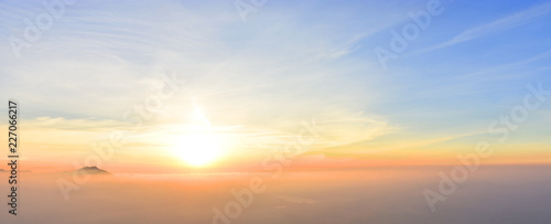 Beautiful colorful sunset at the edge of the Alps with some mountains sticking out of the haze (Bavaria, Germany). Copy space for multiple purposes.