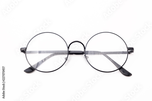 Round black-rimmed glasses are located frontally on a white background. Isolated.