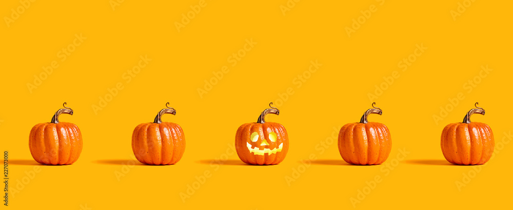 Fototapeta premium Halloween orange pumpkins on an orange background