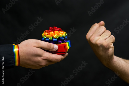 Representative of the LGBT community. Refusal of his proposed holiday gift with symbols. In response, the threat is expressed.