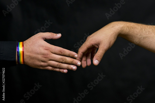 Representative of the LGBT community. Hands reach out for a handshake with a young man.