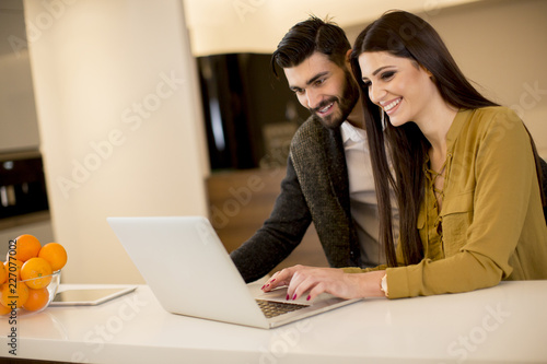 Couple looking at laptop in...