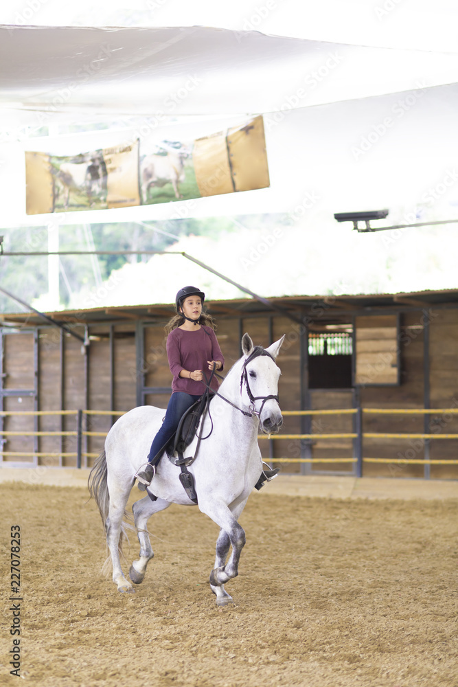 Obraz premium Beautiful Teenager Riding a Horse