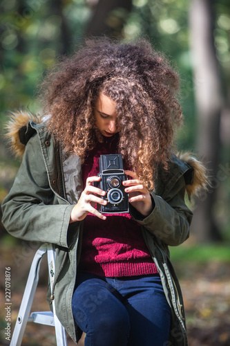 Teen girl with retro camera...