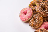 Donuts glazed with sprinkles on a light background
