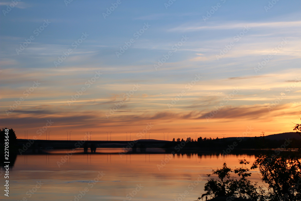 Sunset in the North, midnight sun over the river in Rovaniemi, Finland