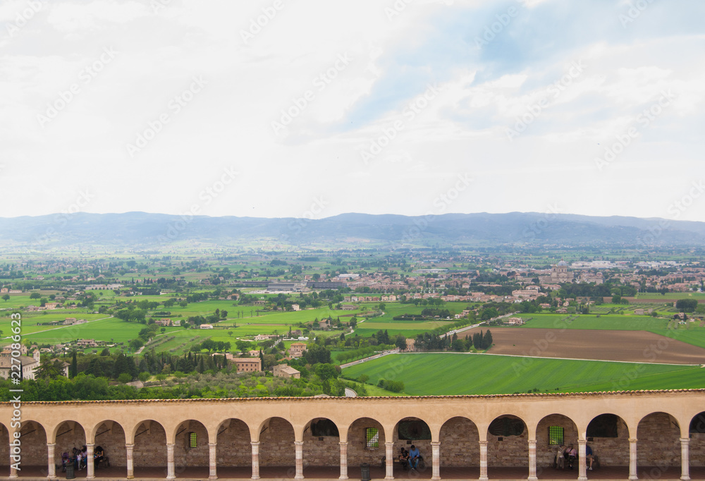 Landscape of Assisi with colonnade of the monastery courtyard seen from the church of San Francesco