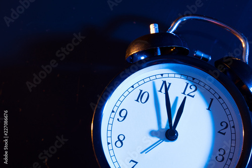 Fotografie Five minutes to midnight on retro analog clock