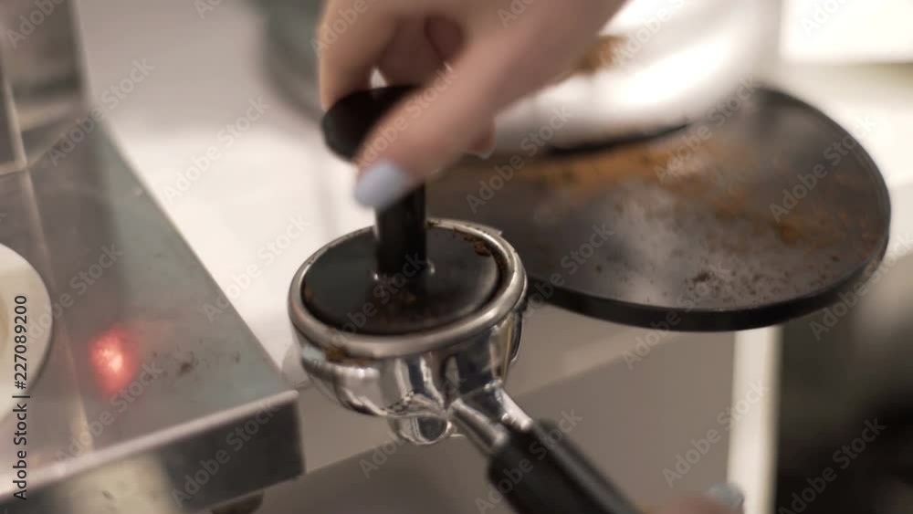 Bartender starts to prepare a double espresso Bartender starts to prepare a double espresso