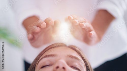 Close Up Of A Relaxed Young Woman Having Reiki Healing Treatment photo