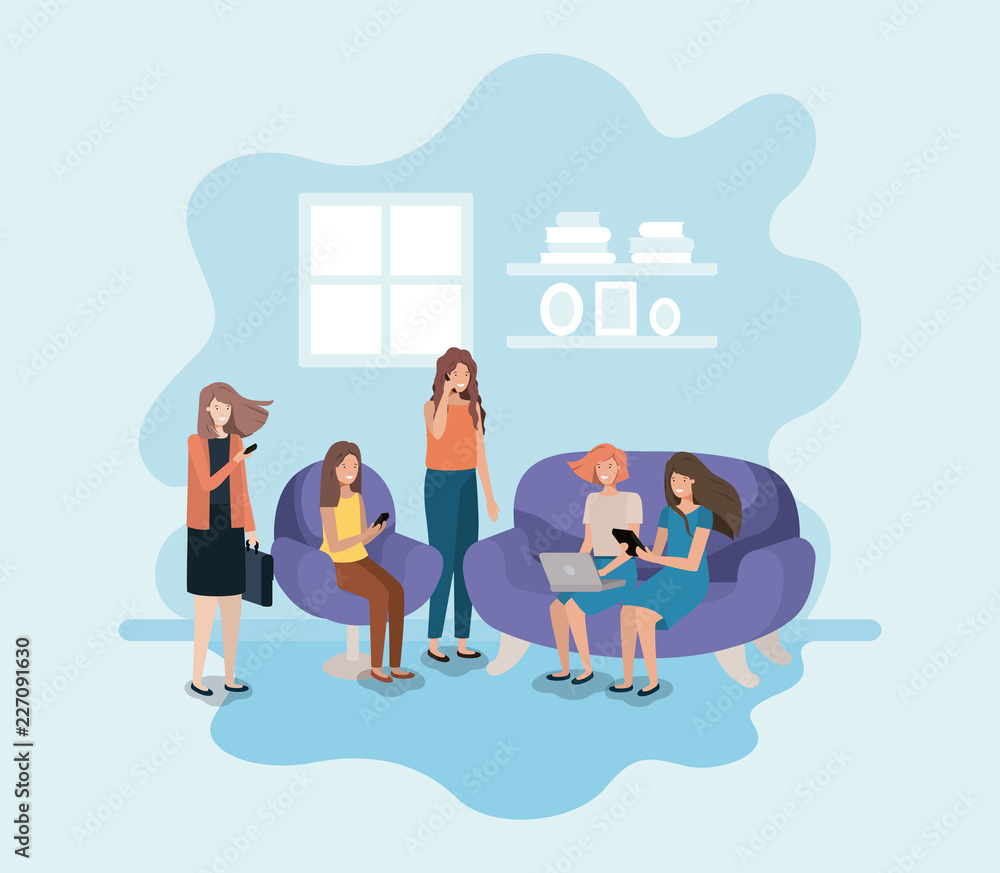 group of women in living room using technology