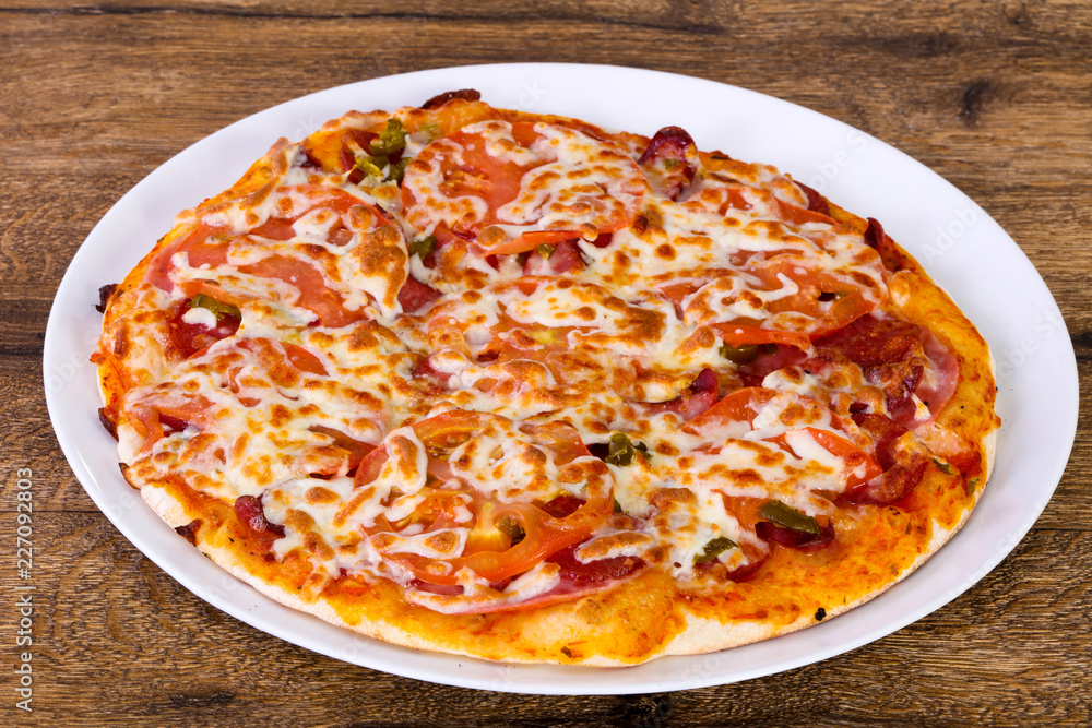 Pizza with sausages and tomato Pizza with sausages and tomato