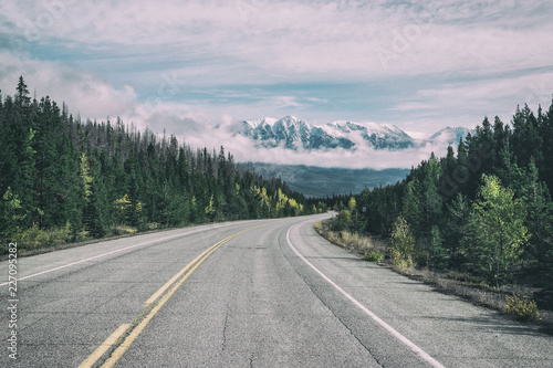 Empty highway heading up to mountains,Alberta,Canada © Martin Capek
