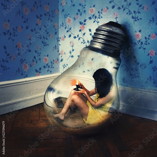 Digitally generated image of woman sitting in light bulb