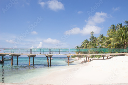 Bridge at a white sand beach and turquoise waters in San Andres, Colombia