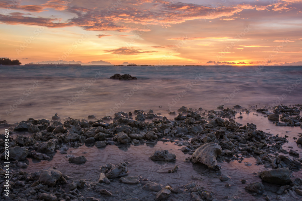 The sea and the dramatic twilight sky on rocky beach at Royal Island