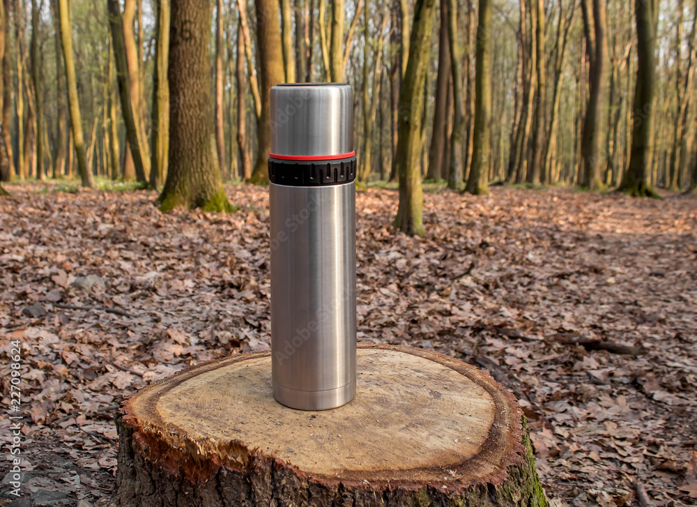 thermos of hot tea in spring cool morning thermos of hot tea in spring cool morning