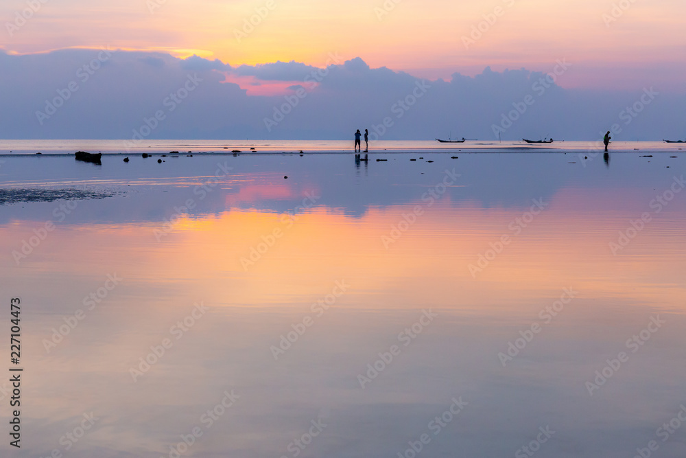 Silhouette of couples have sweet time on the sunset beach, Copy space include.