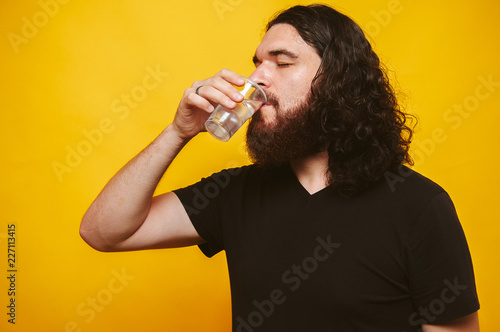 Bearded man drinks water