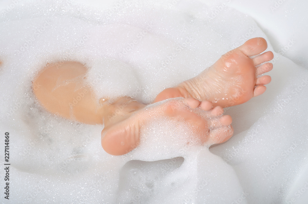 Beautiful woman in bath foam beauty health legs fingers care body water Beautiful woman in bath foam beauty health legs fingers care body water
