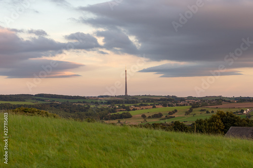 View of the Emley Moor Tower by the light of the setting sun. Rural landscape of England.