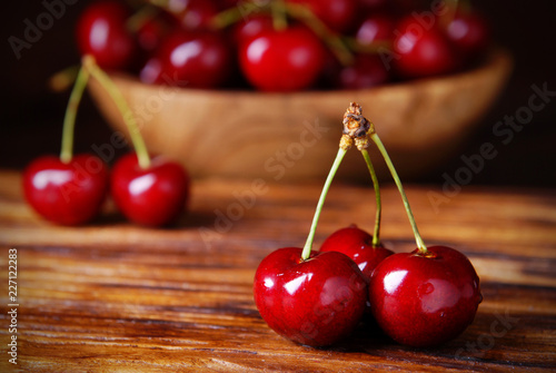 Sweet cherries on wooden background.