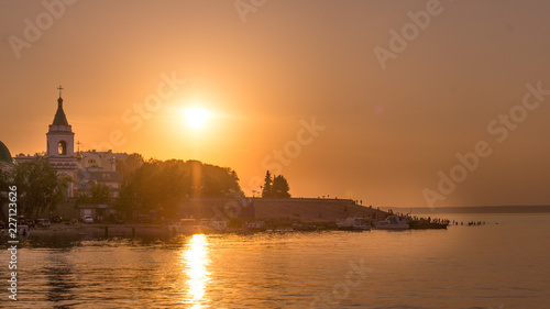 Sunset, the sunset over the Orthodox church on the river Volga