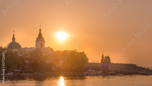 Sunset, the sunset over the Orthodox church on the river Volga