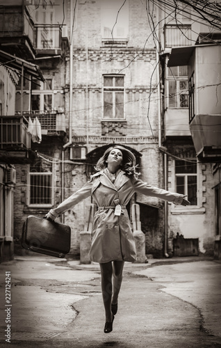 girl on the yard with suitcase in Odessa.. Image in black and white color style