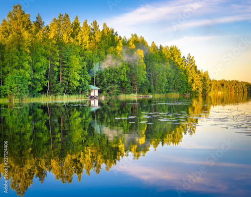 Tampere Finland lake reflections on water with little house on the water, beautiful sky with many colors and trees
