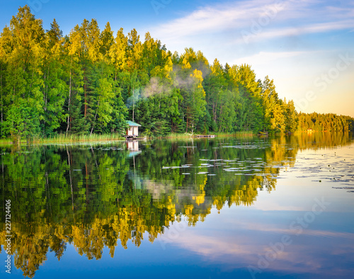 Tampere Finland lake reflections on water with little house on the water, beautiful sky with many colors and trees photo