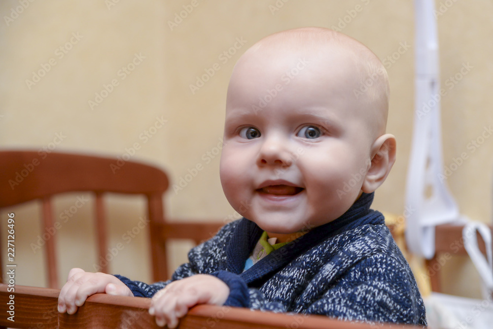 Funny baby boy standing in a crib Funny baby boy standing in a crib