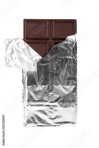 Dark chocolate in foil on a white background.