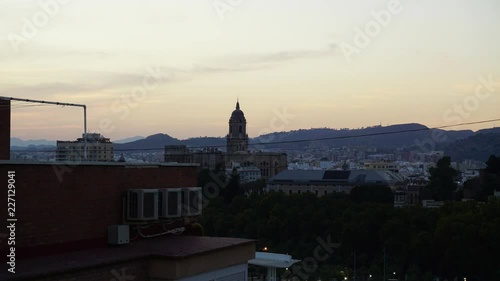 Sunset in Malaga spain on the bell tower and city lights