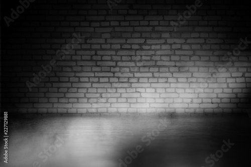 Background of empty dark room with concrete floor. Empty brick walls, neon light, smoke.