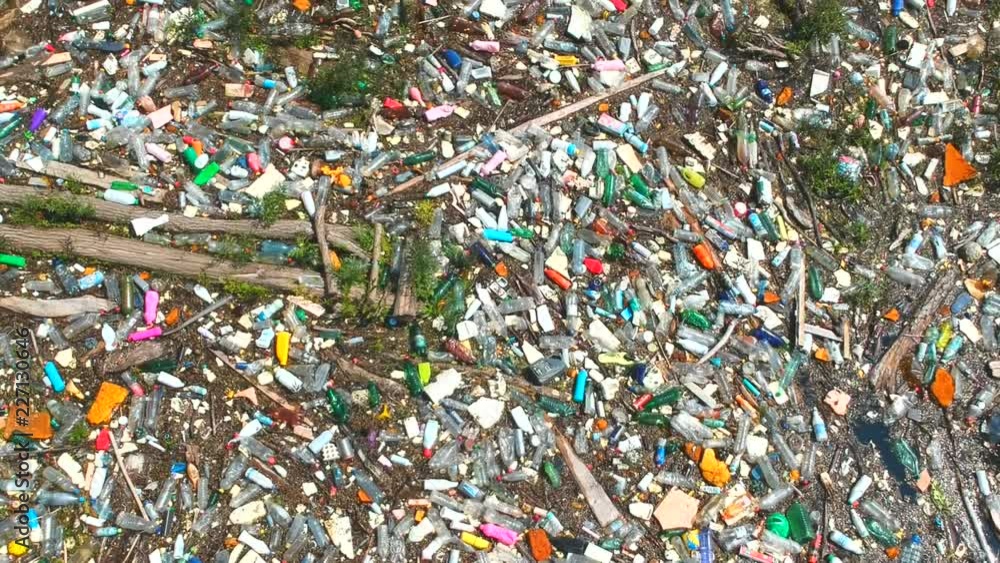 Plastic bottles in a polluted river water. Aerial view, drone view Plastic bottles in a polluted river water. Aerial view, drone view