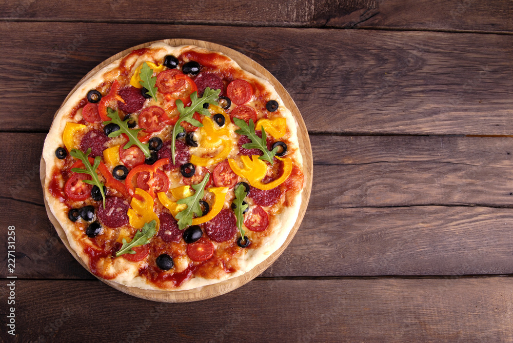 Italian pizza on a wooden background.