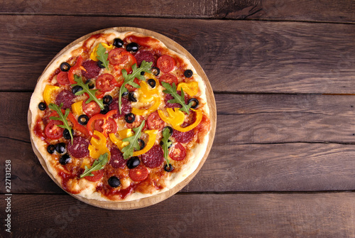 Italian pizza on a wooden background.