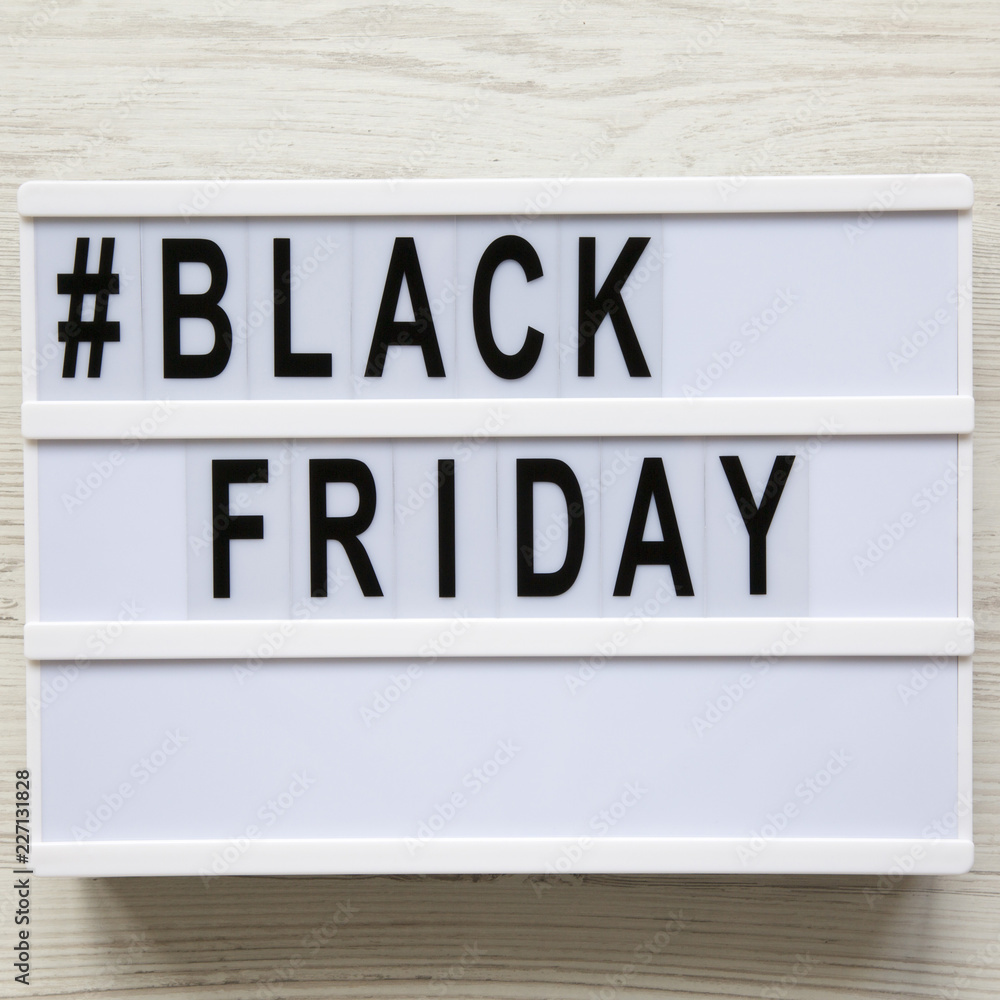 'Black friday' word on lightbox over white wooden background, overhead view. Flat lay, from above, top view. 'Black friday' word on lightbox over white wooden background, overhead view. Flat lay, from above, top view.