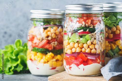 Obraz na plátně Three glass jars with layering various vegan salads for healthy lunch