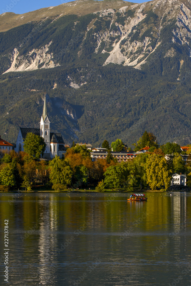 Fototapeta premium Lake Bled in Slovenia is the oldest medieval town in Slovenia .Tourist boat on the on Lake Ble. Mountains in background. Slovenia, Europe. European travel.